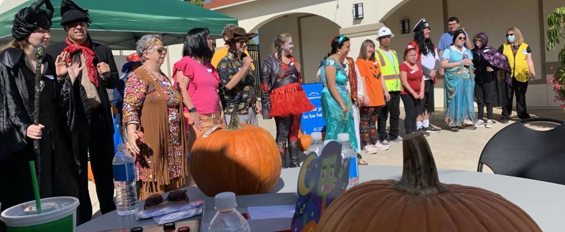 A group of people standing around an outdoor area.