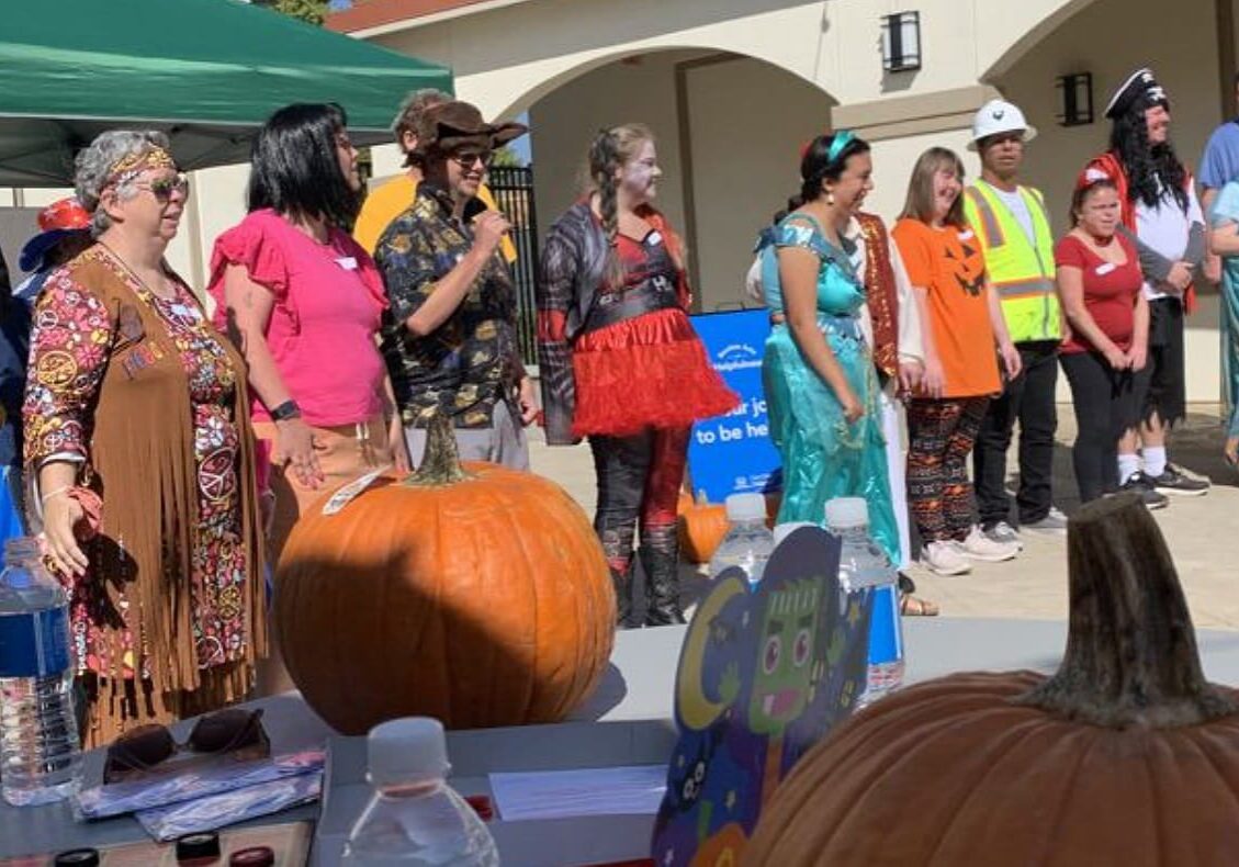 A group of people standing around an outdoor area.